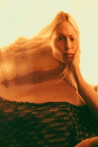 orange neutral color scheme blonde woman portrait