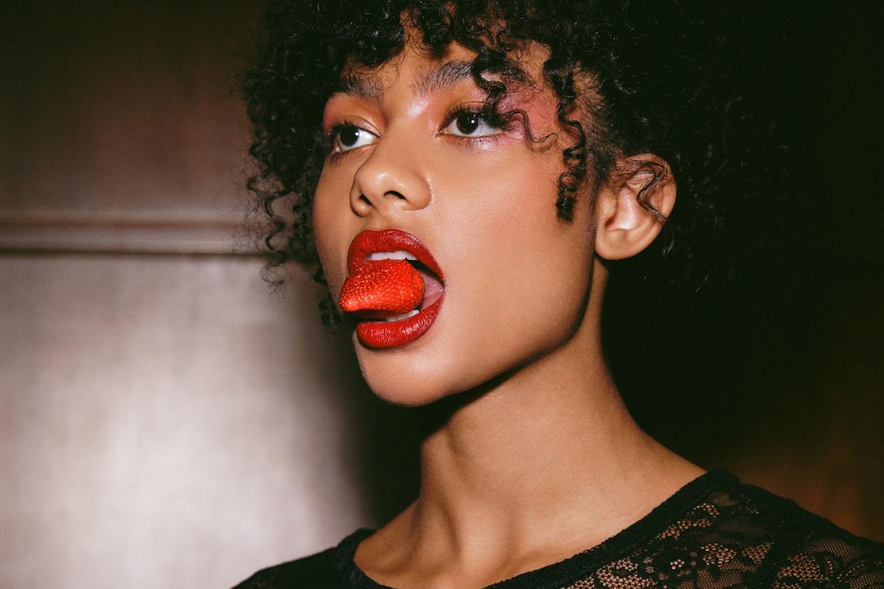 woman with red lipstick and strawberry